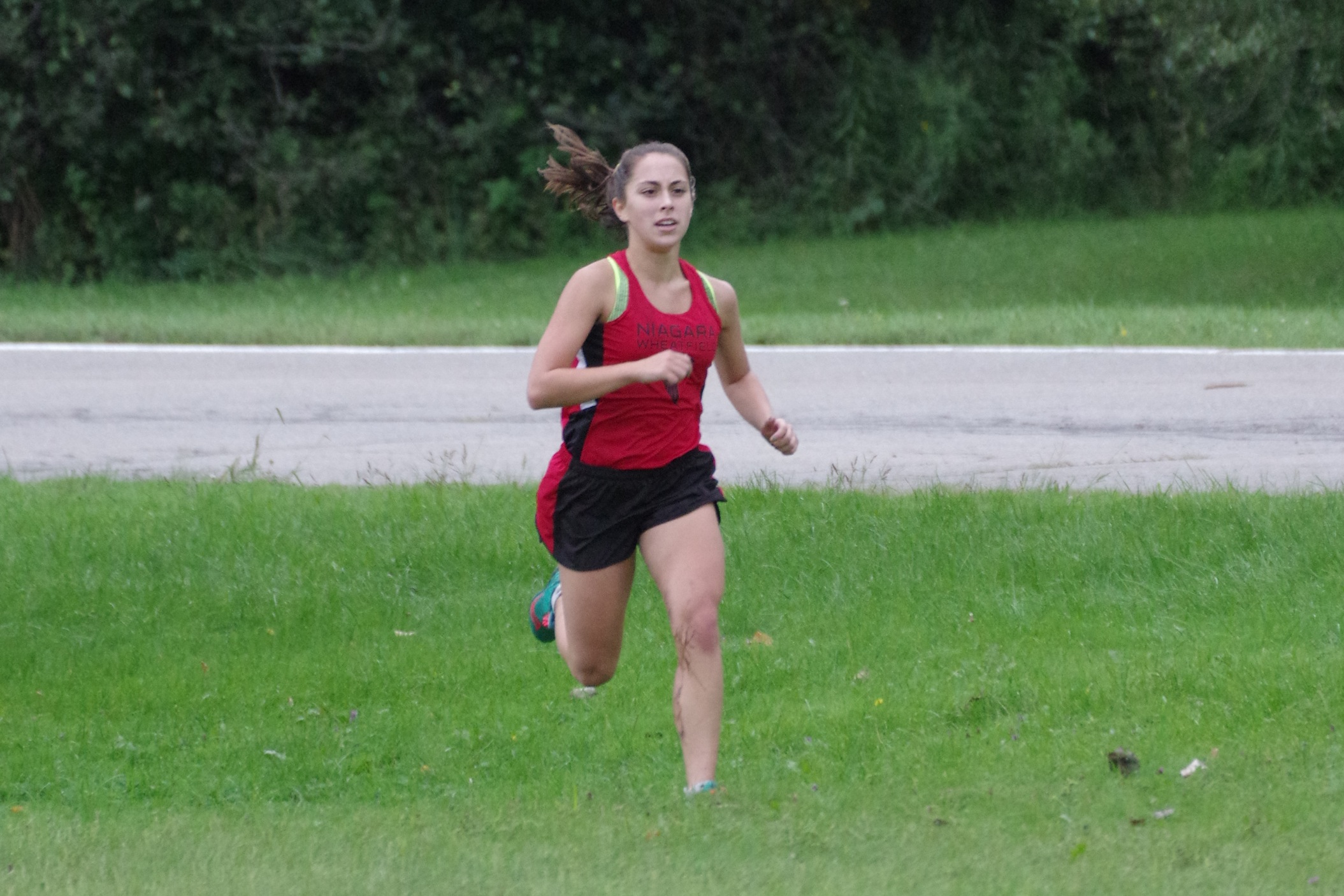 Victoria Achtziger-Hughes running in action during a recent meet. (Photo by Larry Austin)
